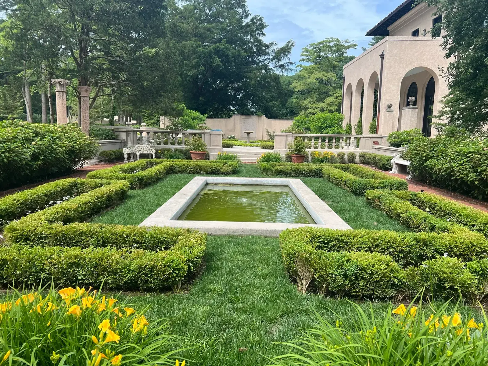 Formal water feature and clipped hedging