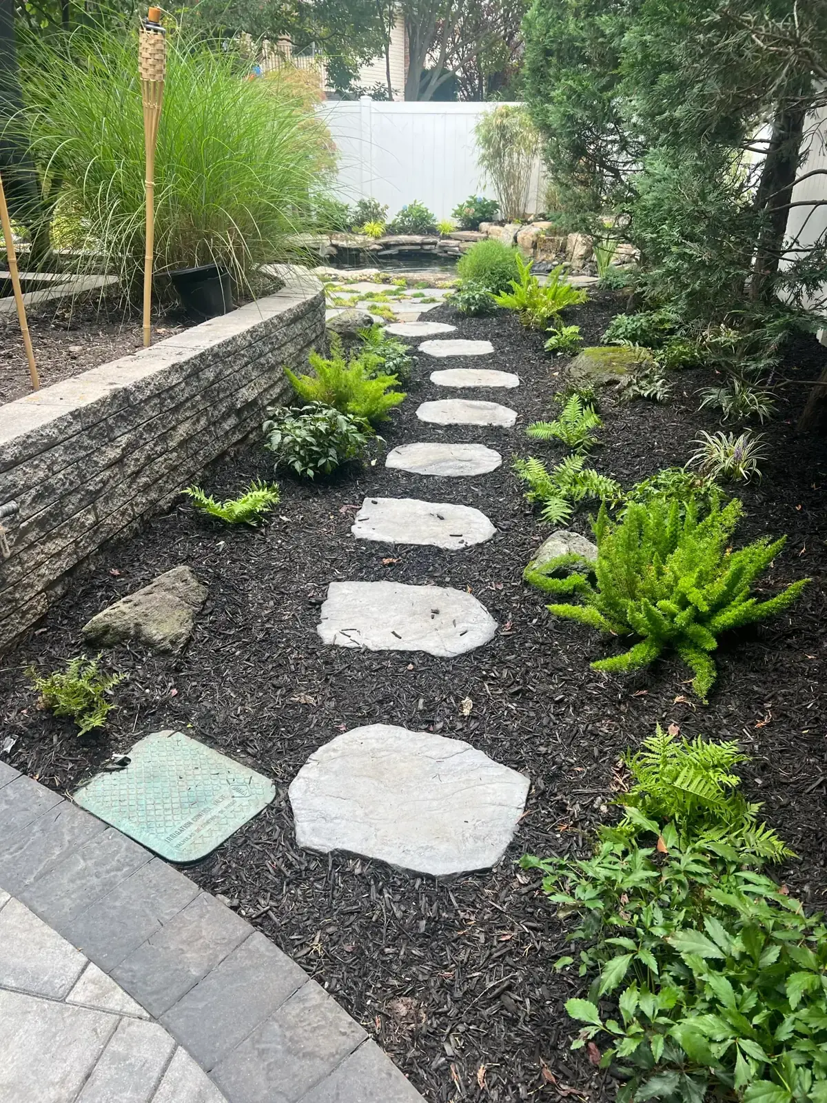 Fieldstone stepping stone path and stone wall in Nassau County