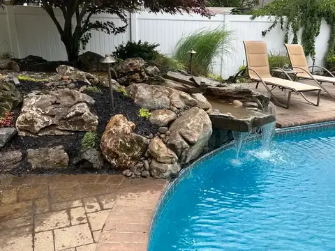 Poolscape stone terrace in Nassau County, by Scott Anderson Design.