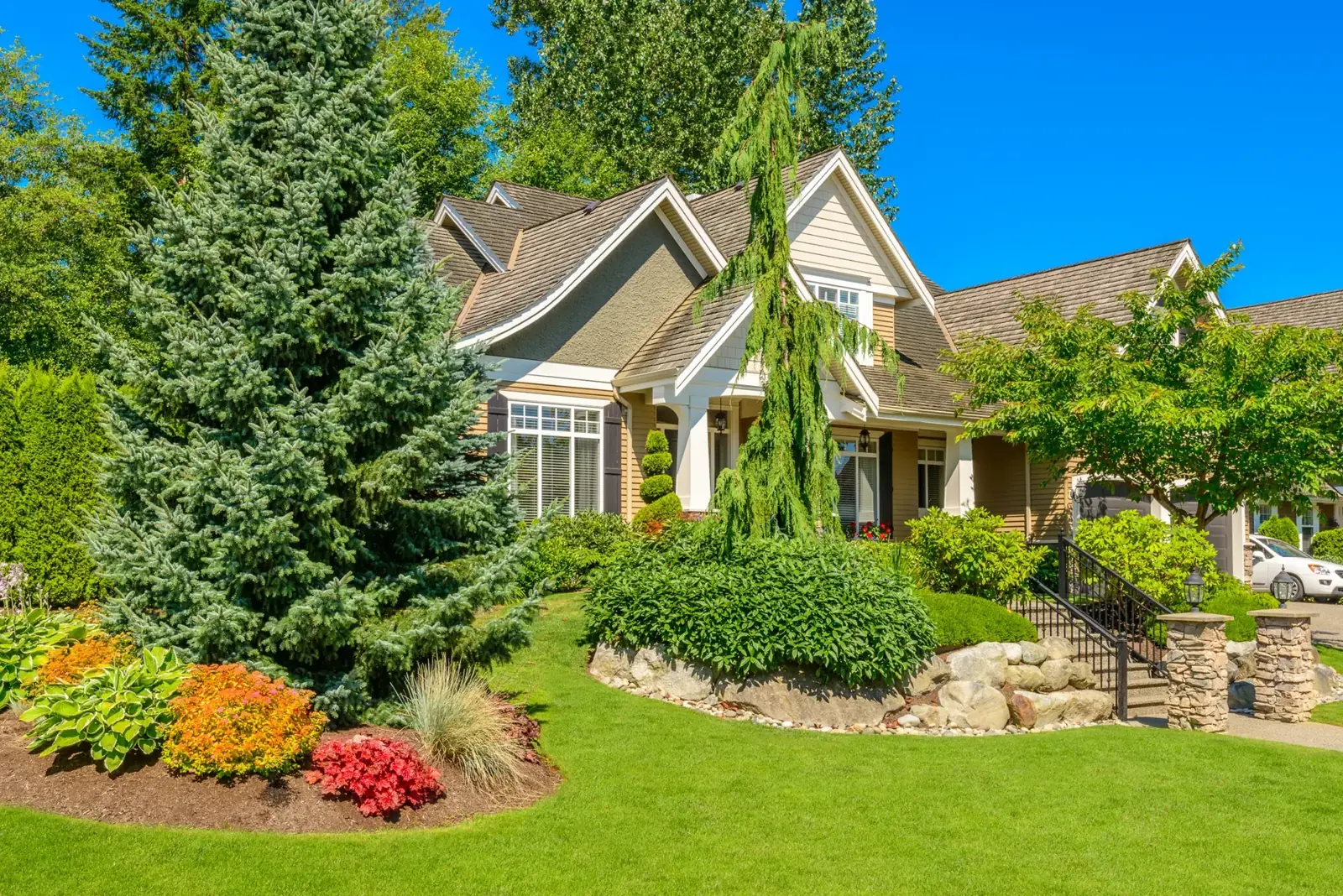 Front yard landscape design with layered plantings in Bellmore, NY