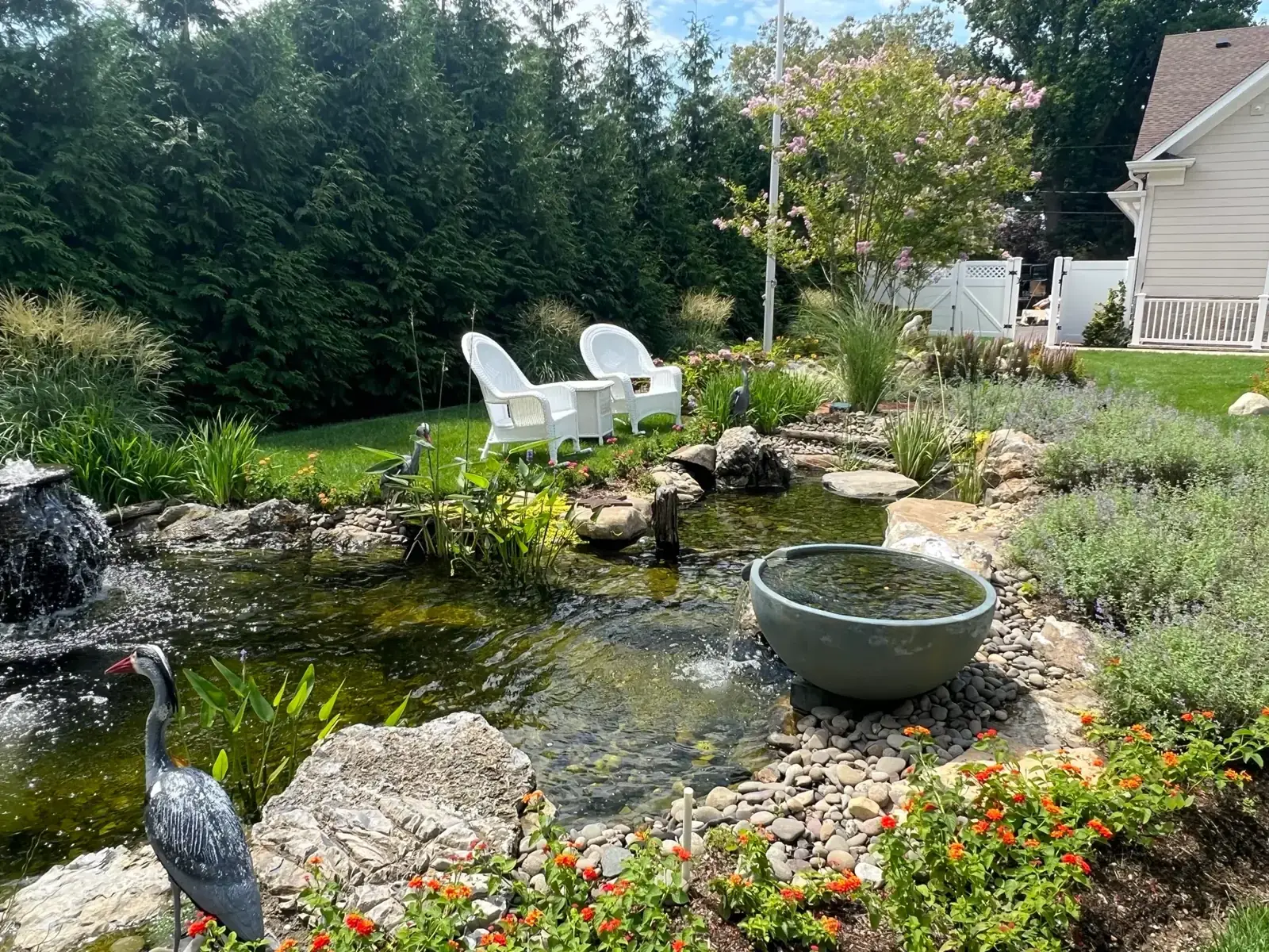 Rock ledge waterfall into an ecosystem pond