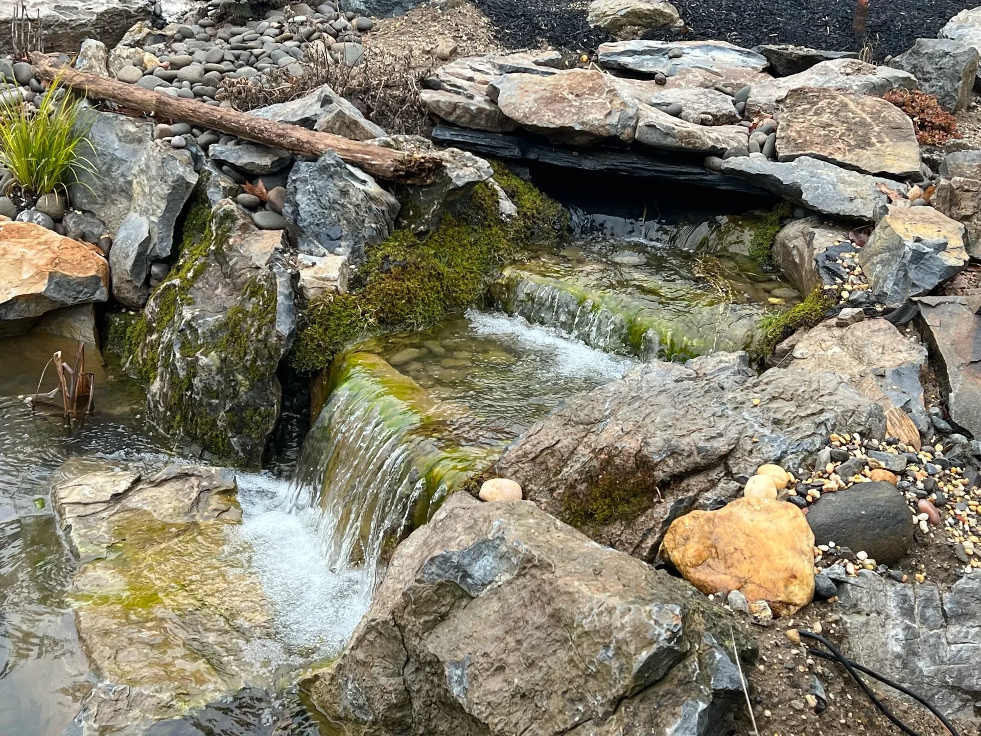 Russo Multi-Feature Water Garden in Rockville Centre, NY after construction, showing the finished waterfall