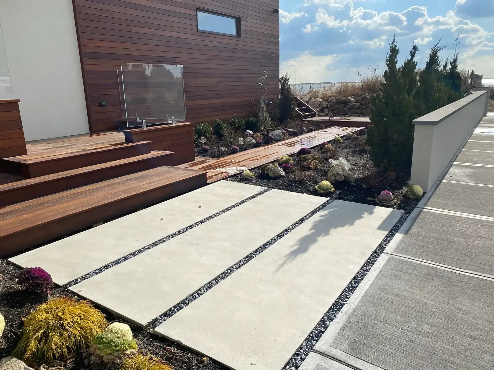 Concrete slab terrace with gravel joints and an ipe deck