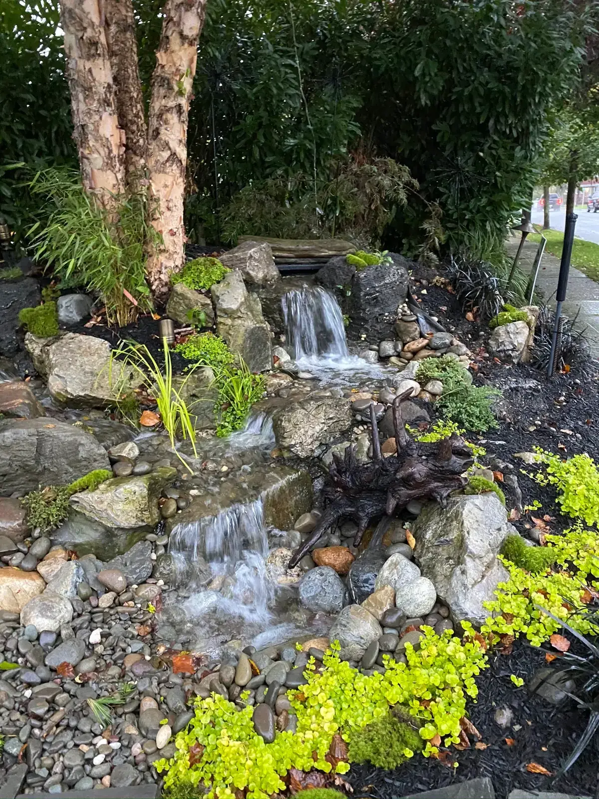 Pondless waterfall in a garden bed
