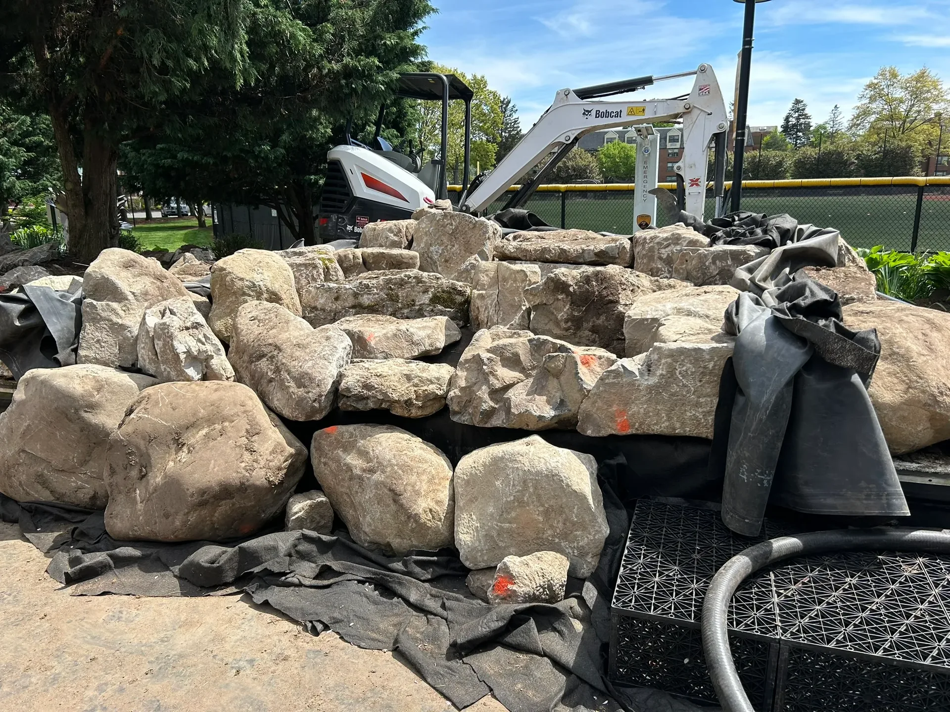 Adelphi University Waterfall in Garden City, NY during construction, with natural boulders being placed
