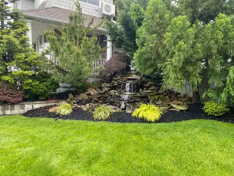 Pondless waterfall planted in Long Island, by Scott Anderson Design.